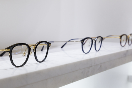 detail view of various eyeglasses lying on a tray.の写真素材