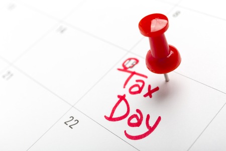 April tax day written and pinned in a calender, close up.の写真素材
