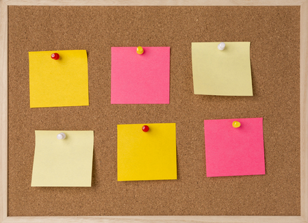 lot a yellow, pink stickry note on wooden frame cork board.の写真素材