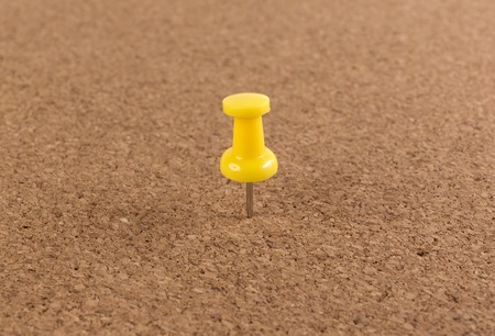 yellow pin on Cork board texture background.の写真素材