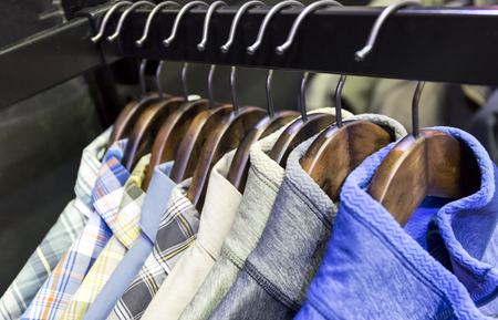 Clothes hang on a shelf in a designer clothes store in Melbourne, Australia.の写真素材
