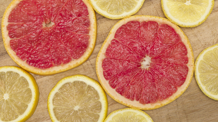 Colorful citrus fruit - lemon, grapefruit - slices background.の写真素材
