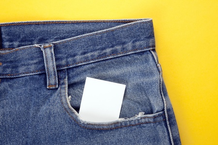 blank paper in the jeans pocket with yellow backgraundの写真素材