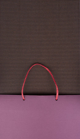 Paper bag with handles on brown corrugated cardboard