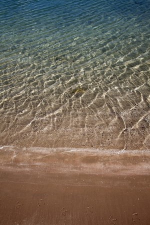 A background of sun and shadows on sandy ocean floor の写真素材