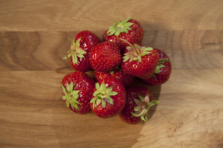 Fresh ripe red strawberries on wooden textured table topの写真素材