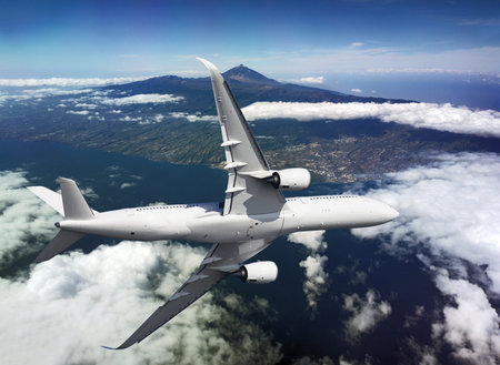 Airplane flying over the island and mountains with a cloudsの写真素材