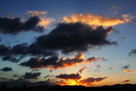 Fluffy clouds and sunsetの写真素材