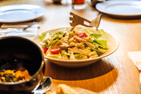 A crispy romaine tossed in homemade caesar dressing served with croutons & fresh tomato in a pizzeria chain restaurant at Huashan Taipei, Taiwan.の写真素材