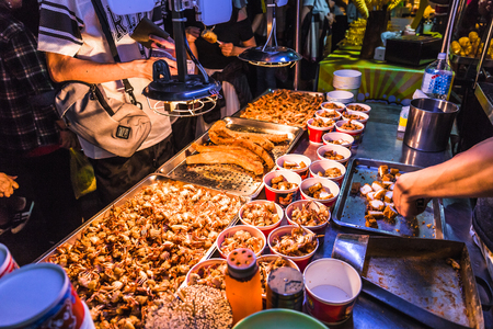 This snack food is a squid which is deep fried till golden brown and extremely crispy. The squid is lightly coated with salt and pepper at the Raohe night market.の写真素材