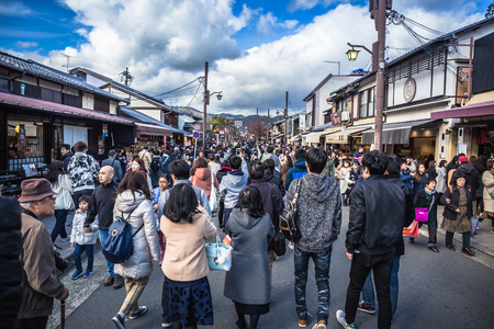Kyoto, Japan - November 23, 2018: Crowds of people walking on the main street in Arashiyama town during the colorful autumn season.のeditorial素材