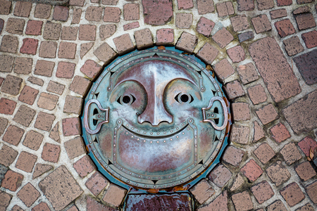 Tokyo, Japan - November 30, 2018: The manhole cover designed like a robot smiling face at Ghibli Museum.のeditorial素材