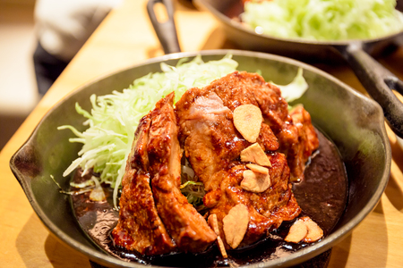 Tokyo Tonteki is one of the popular food at Shibuya area. Tonteki means pork loin steak, the pork is juicy and its grilled in a frying pan with their original sauce.の写真素材