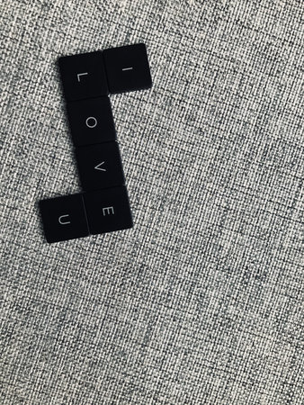 The word i love you made of black cubes on a gray background