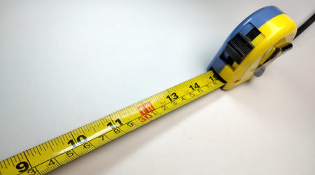 Measuring tape on a white background. Close-up view.