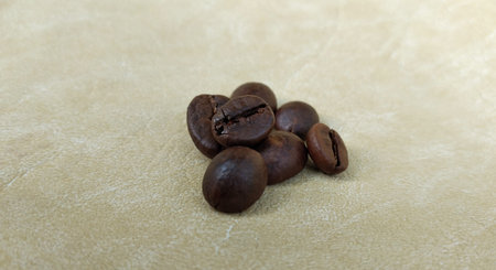 Coffee beans on a beige background. Close-up.