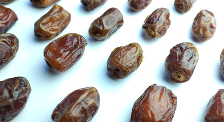 Dried dates on a white background. Close up. Top view.