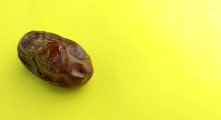 Dates fruit on a yellow background with copy space for text.