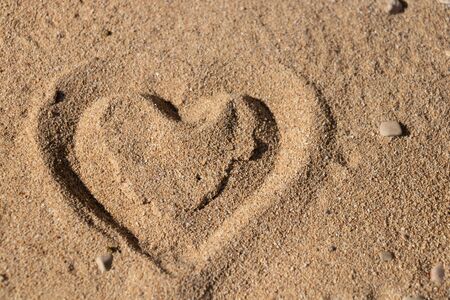 Heart shape in the sand on the beach with nice textureの写真素材