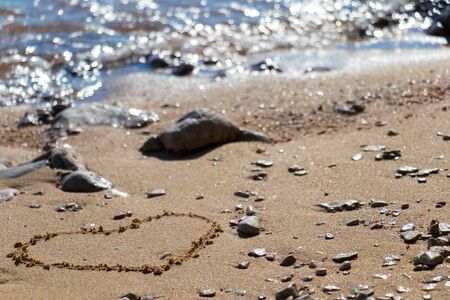 Heart shape in the sand on the beach with nice textureの写真素材