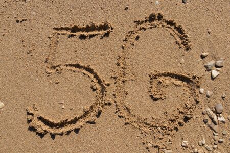 5G written on the sandy beach near the seaの写真素材
