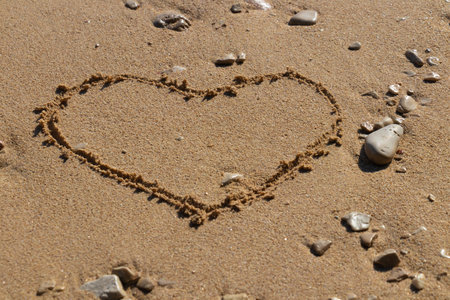 Heart shape in the sand on the beach with nice textureの写真素材