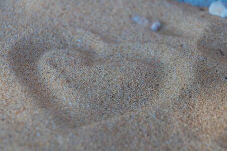 Heart shape in the sand on the beach with nice textureの写真素材