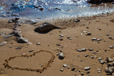 Heart shape in the sand on the beach with nice textureの写真素材