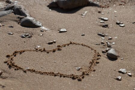 Heart shape in the sand on the beach with nice textureの写真素材
