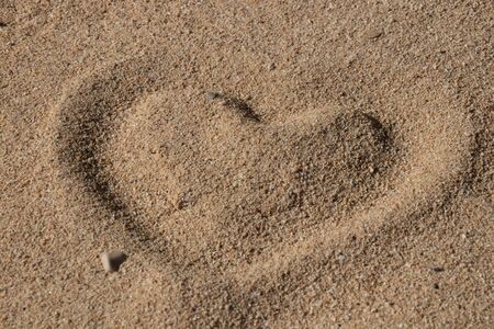 Heart shape in the sand with nice shadows and textureの写真素材
