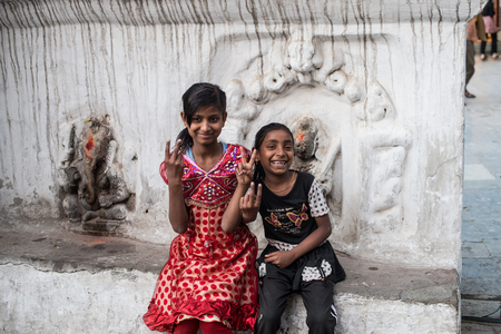APRIL 14, 2014 - KATHMANDU, NEPAL : 2 Nepali girls smiling in the temple near Kathmandu squareのeditorial素材