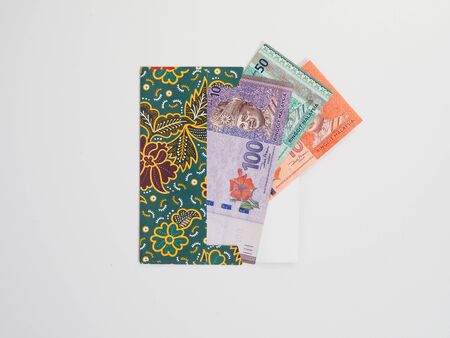 A green packet  or known as duit raya on isolated white backgroundの写真素材