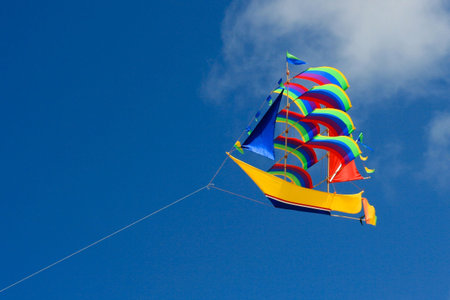 Colorful ship kite in the blue sky.の写真素材
