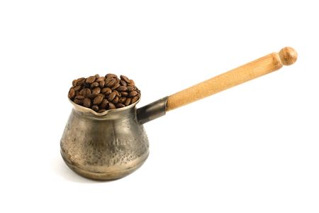 copper coffee pot with wooden handle isolated on whiteの写真素材