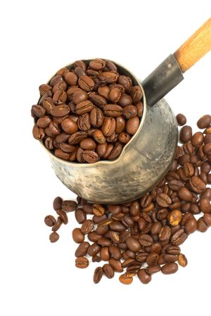 copper coffee pot with wooden handle isolated on whiteの写真素材