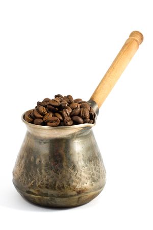 copper coffee pot with wooden handle isolated on whiteの写真素材