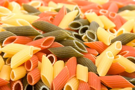 Colored raw penne as background.の写真素材