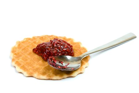 Cookie and spoon with raspberry jam,  isolated on white.の写真素材
