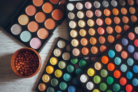 Multicolored eyeshadows on the white wooden tableの写真素材