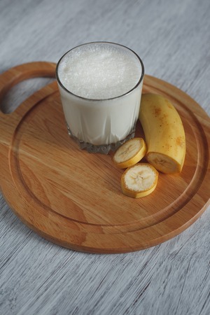 Delicious milkshake with banana and walnut crumbの写真素材