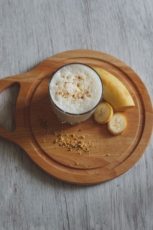 Delicious milkshake with banana and walnut crumbの写真素材