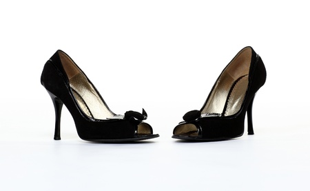 Pair of high-heeled black shoes isolated on white backgroundの写真素材