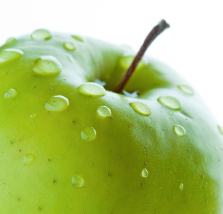 Healthy eating: closeup of green apple with drops of waterの写真素材
