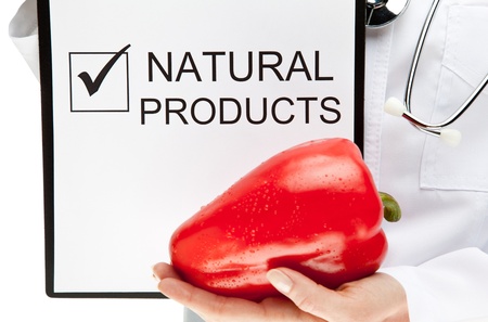 Doctor advising healthy natural products, closeup of doctor's hands holding clipboard with marked checkbox and words NATURAL PRODUCTS, and sweet pepper, healthy eating concept isolated on whiteの写真素材