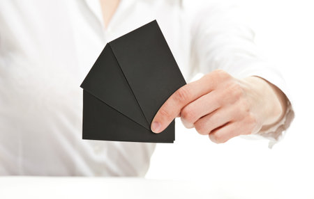 Female hand showing blank cards - you can add your contacts or other information on them, closeup...