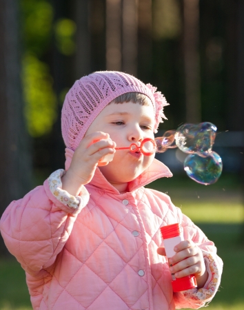Cute little girl making soap bubblesの写真素材