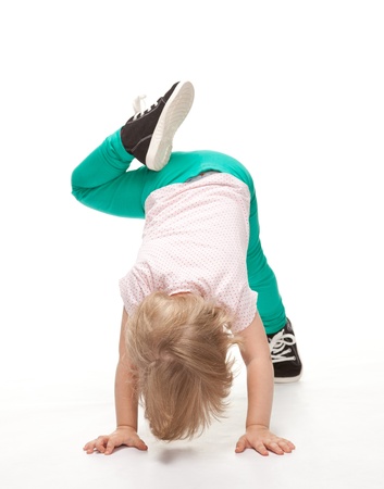 Active little girl doing sport exercises on white backgroundの写真素材