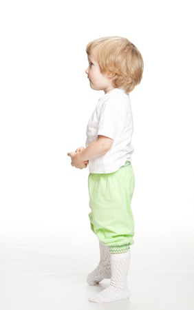 Little child looking at something - full length on white backgroundの写真素材