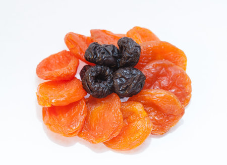 Dried apricots and prunes on white backgroundの写真素材