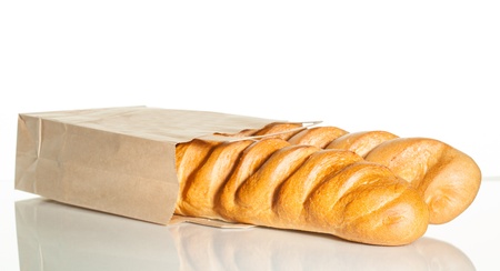 Two loaves in a brown paper bag on white backgroundの写真素材